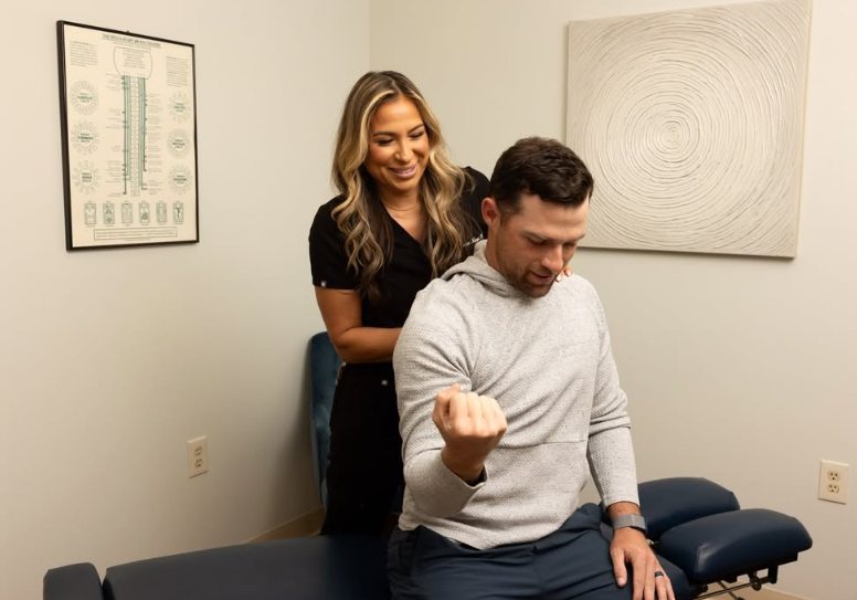 Dr. Nappi guiding a patient through a seated movement check